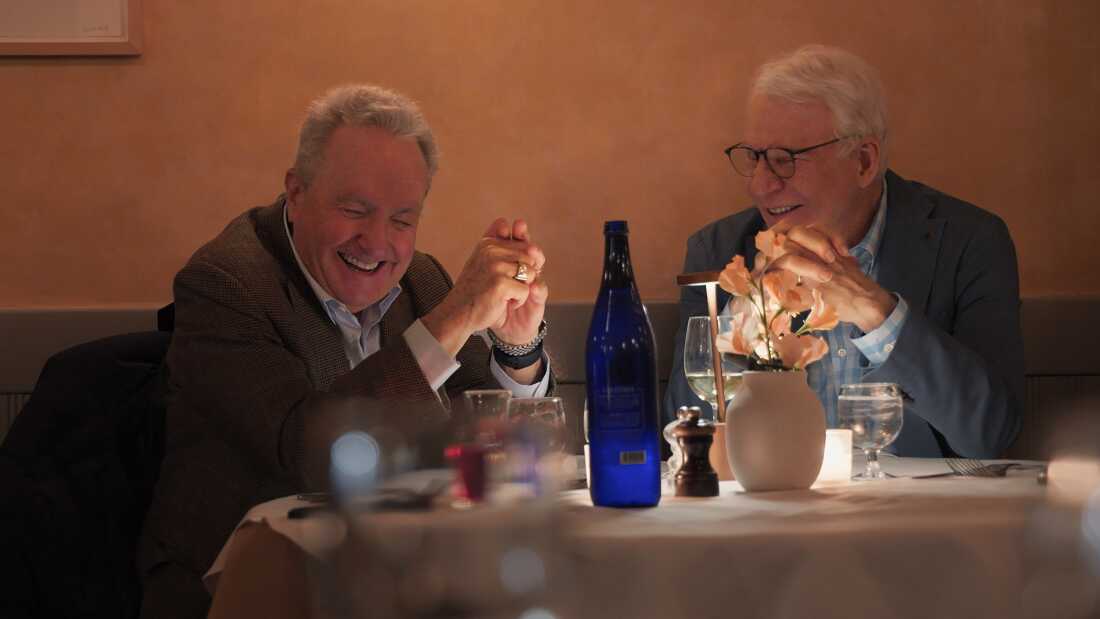 men laughing at table