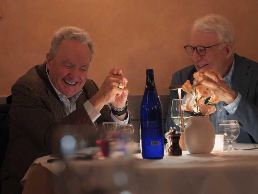 men laughing at table